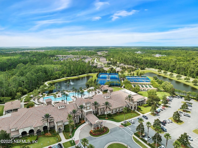 aerial view featuring a water view and a view of trees