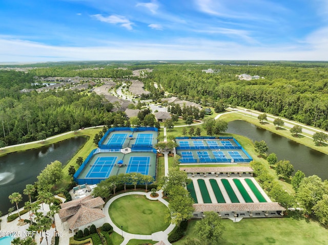 drone / aerial view featuring a water view and a view of trees