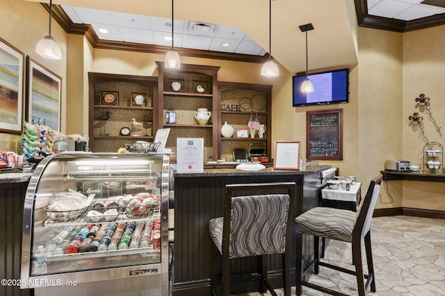 bar with visible vents, baseboards, stone tile flooring, and crown molding