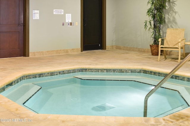 view of pool with an indoor hot tub