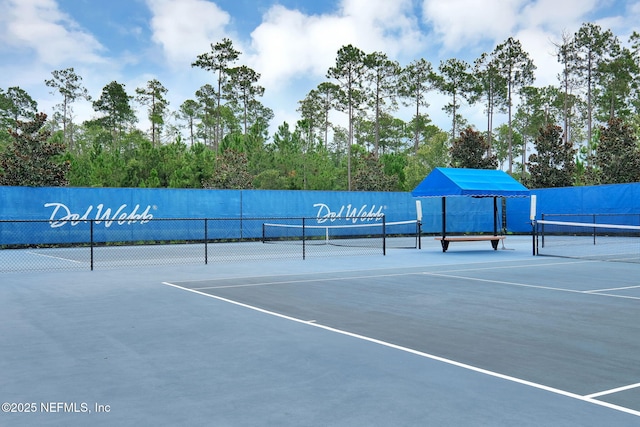 view of tennis court featuring fence