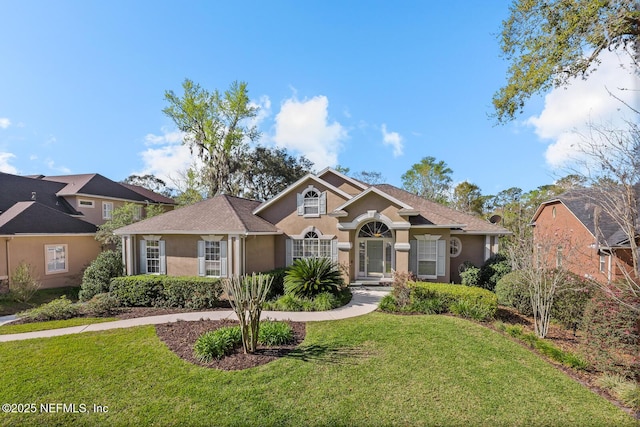 view of front of property with a front lawn and stucco siding