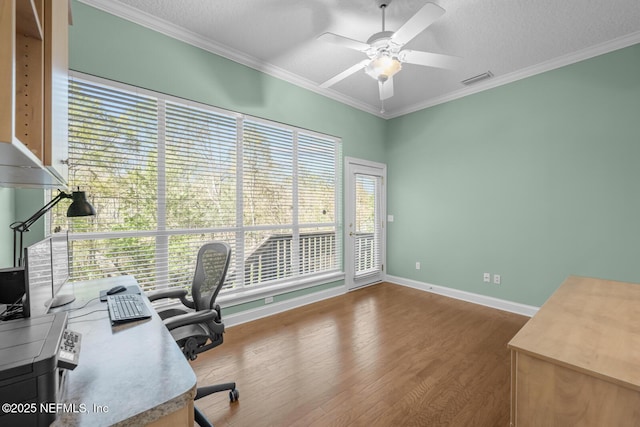 office with a textured ceiling, ornamental molding, wood finished floors, and a ceiling fan