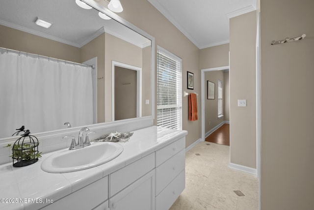 full bathroom featuring crown molding, vanity, and baseboards