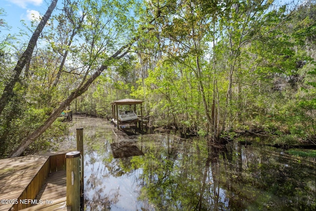 view of dock featuring a forest view