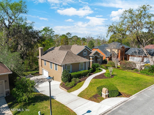 ranch-style home featuring driveway, a shingled roof, a chimney, a front yard, and stucco siding