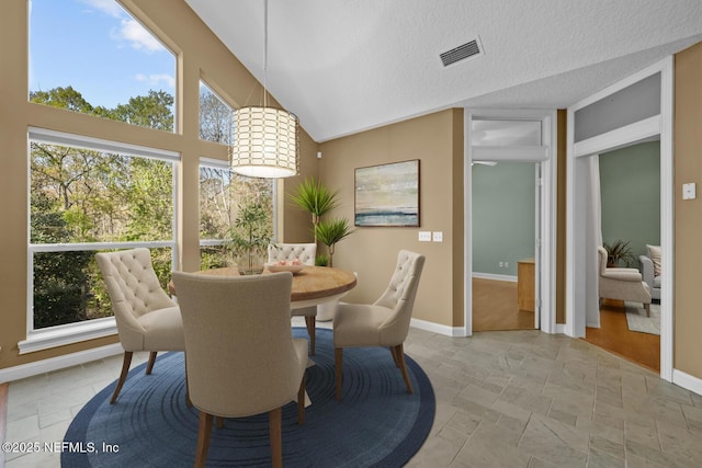 dining space featuring a healthy amount of sunlight, baseboards, and visible vents