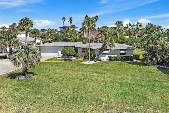 ranch-style home with a front yard, driveway, and an attached garage