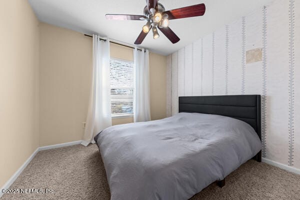 bedroom featuring a ceiling fan, baseboards, and carpet flooring