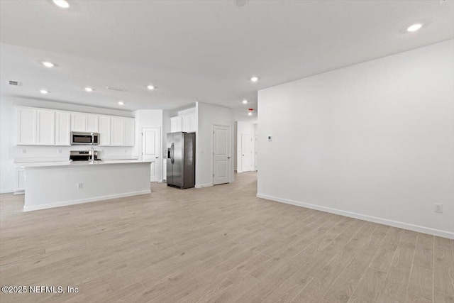 unfurnished living room featuring recessed lighting, baseboards, visible vents, and light wood finished floors