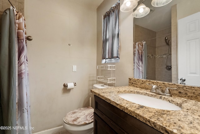 bathroom featuring toilet, tiled shower, and vanity