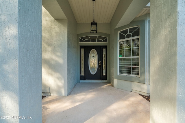 entrance to property with stucco siding