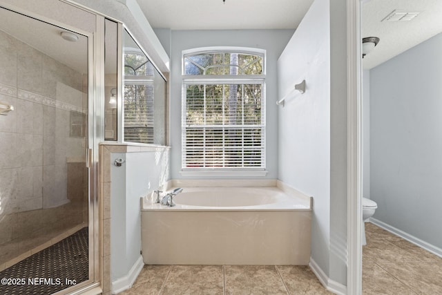 full bath with tile patterned flooring, a garden tub, toilet, baseboards, and a stall shower