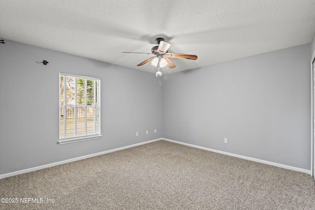 carpeted empty room featuring baseboards, a ceiling fan, and a textured ceiling