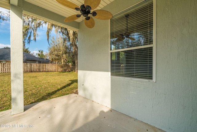 view of patio featuring fence and a ceiling fan