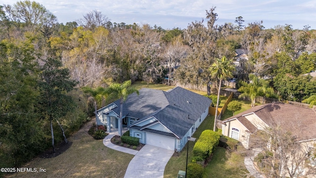 drone / aerial view featuring a view of trees