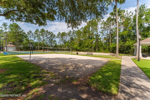 surrounding community with volleyball court and a lawn