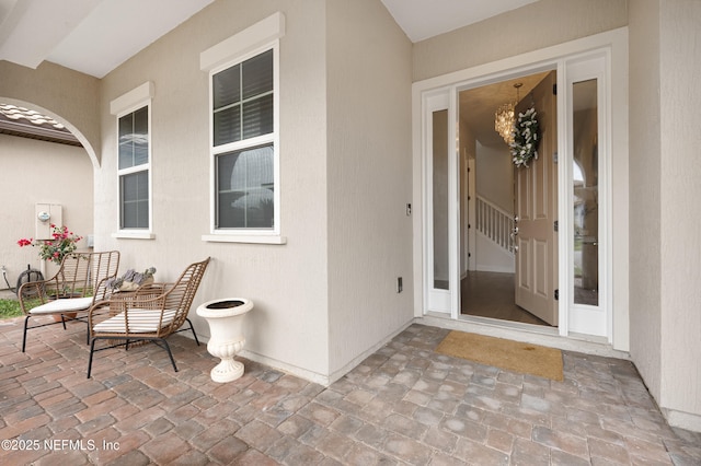 entrance to property with stucco siding