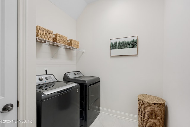 laundry area featuring laundry area, washer and clothes dryer, and baseboards