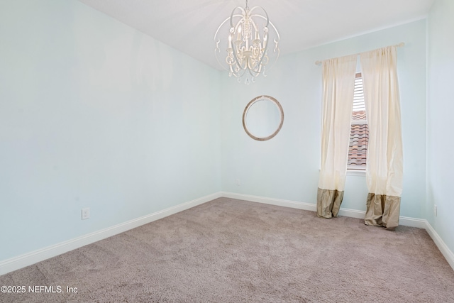 carpeted empty room with baseboards and a notable chandelier