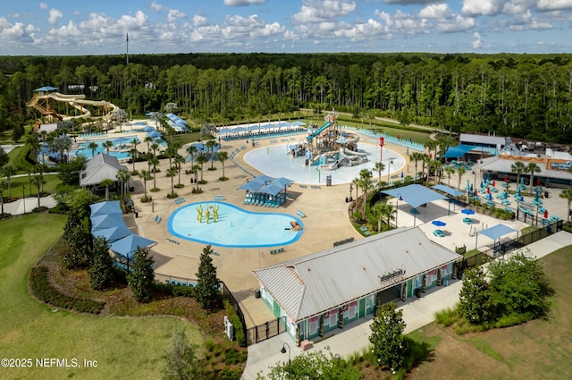 drone / aerial view featuring a wooded view