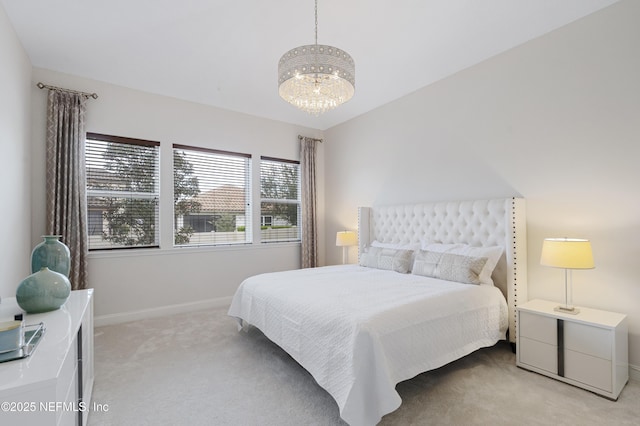 bedroom with light carpet, a notable chandelier, and baseboards