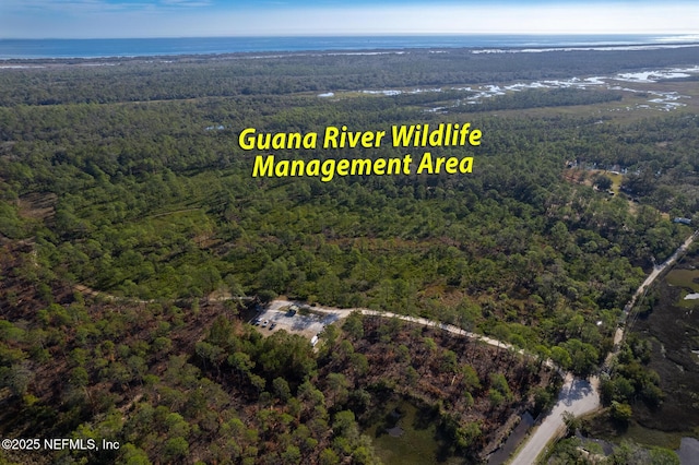 birds eye view of property with a view of trees