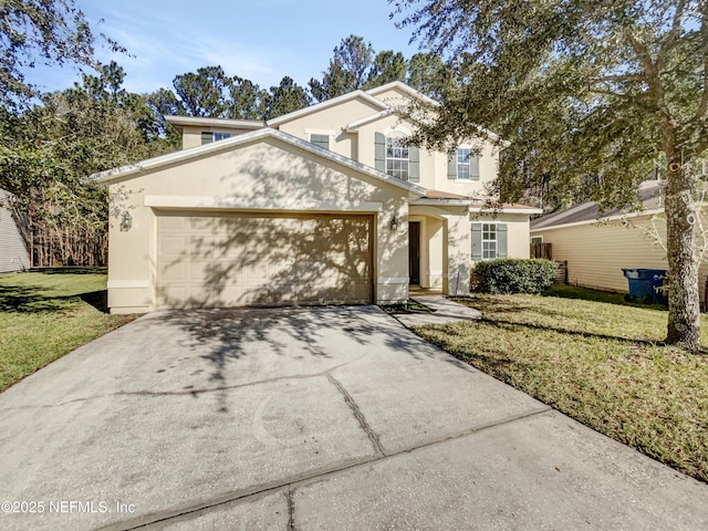 traditional home with driveway, a front yard, an attached garage, and stucco siding