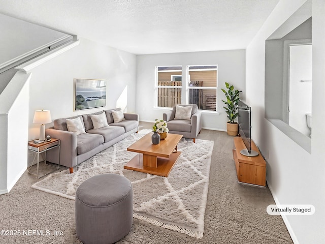 living area featuring a textured ceiling and baseboards