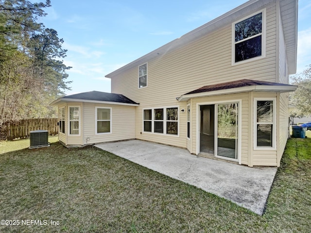 back of property with central air condition unit, a patio area, fence, and a yard