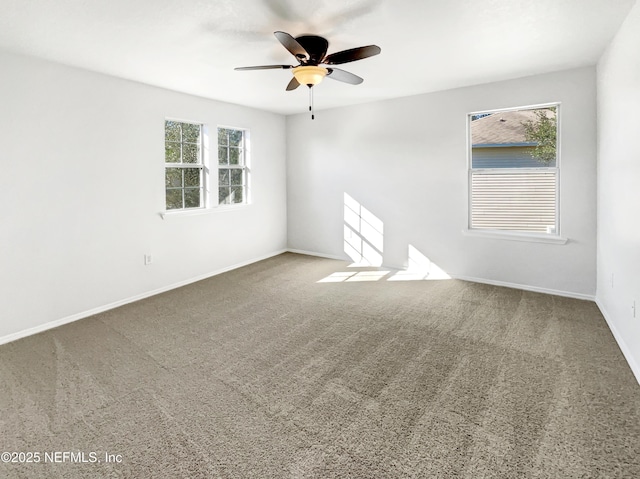 empty room with carpet, ceiling fan, and baseboards