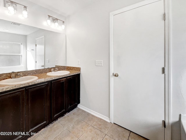 full bathroom featuring double vanity, visible vents, a sink, and tile patterned floors