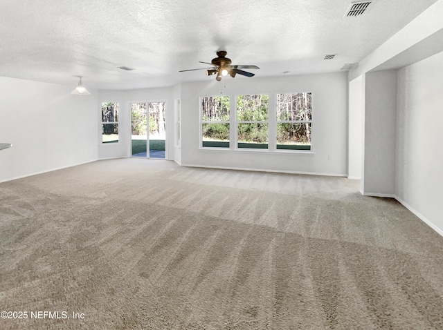 unfurnished living room with light carpet, visible vents, and a textured ceiling