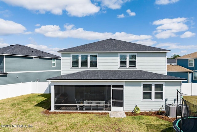 back of house featuring cooling unit, a sunroom, a fenced backyard, and a lawn