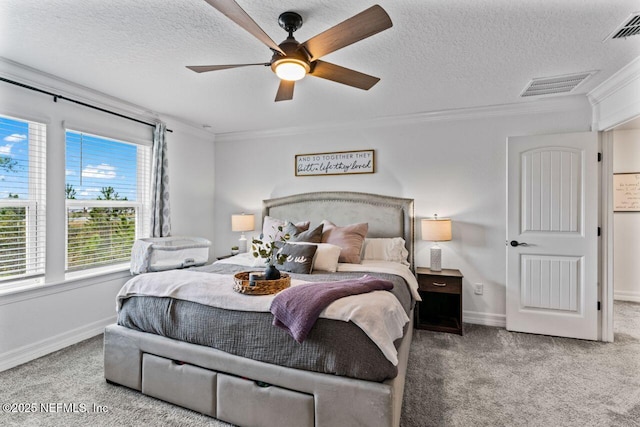 carpeted bedroom featuring a ceiling fan, visible vents, crown molding, and a textured ceiling