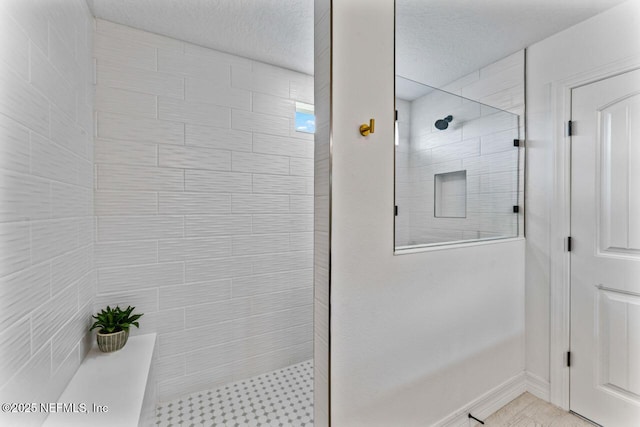 bathroom with a walk in shower and a textured ceiling