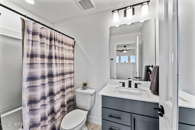 full bathroom featuring visible vents, a textured wall, toilet, wood finished floors, and vanity