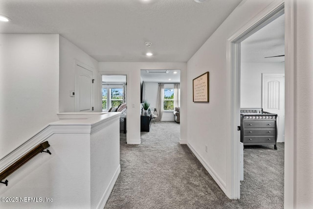 corridor with carpet floors and baseboards