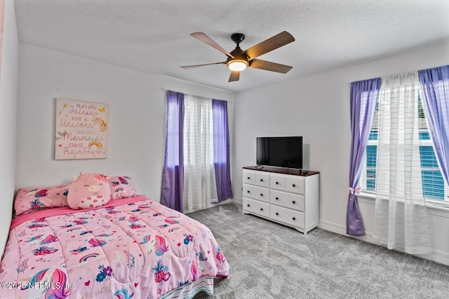 bedroom featuring carpet floors, a textured ceiling, baseboards, and a ceiling fan