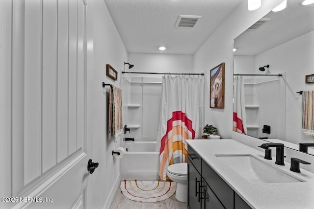 bathroom featuring toilet, shower / bath combo, vanity, and visible vents