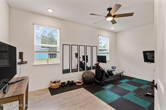 exercise room with recessed lighting, wood finished floors, a ceiling fan, and baseboards