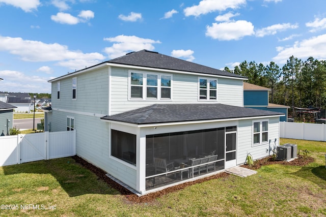 back of house with a fenced backyard, central AC, a sunroom, a yard, and a gate