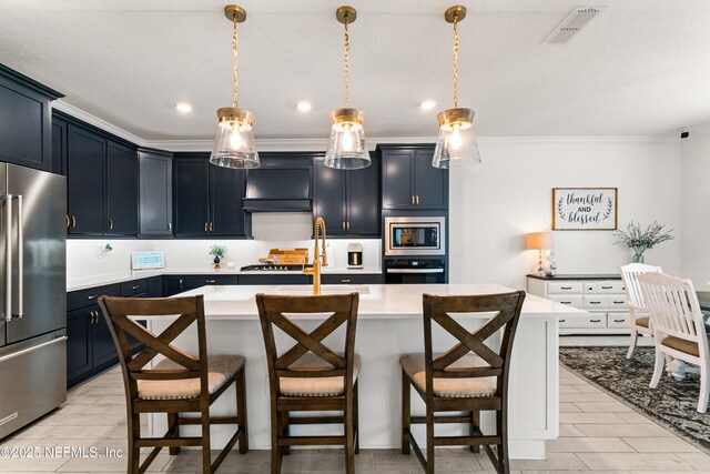 kitchen with a breakfast bar, visible vents, appliances with stainless steel finishes, and light countertops