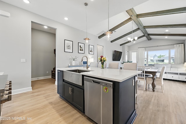 kitchen featuring lofted ceiling with beams, a kitchen island with sink, light countertops, stainless steel dishwasher, and light wood finished floors