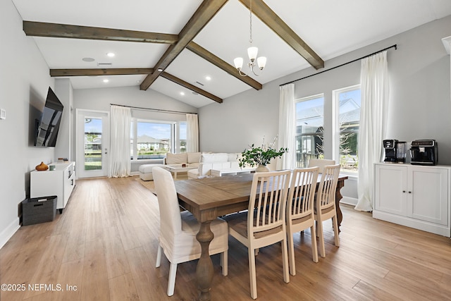 dining area featuring light wood-style floors, a chandelier, vaulted ceiling with beams, and baseboards