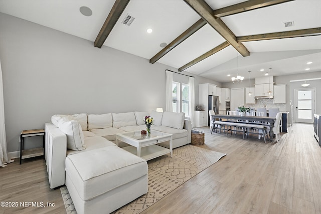 living area featuring light wood-style floors, visible vents, lofted ceiling with beams, and an inviting chandelier