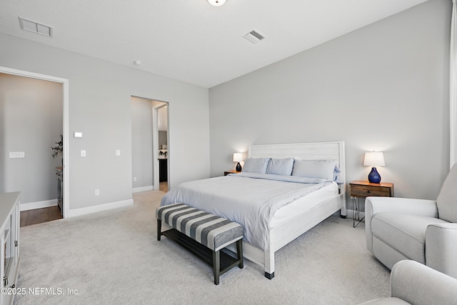 bedroom with visible vents, light carpet, and baseboards