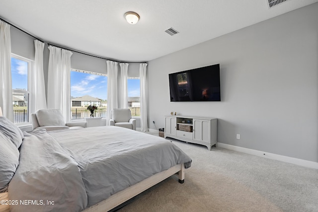 bedroom featuring light carpet, baseboards, and visible vents