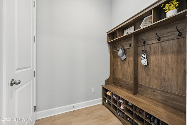 mudroom with light wood finished floors and baseboards