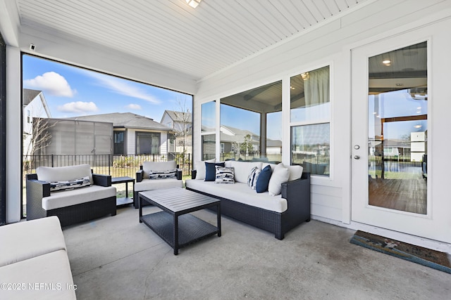 sunroom featuring a residential view